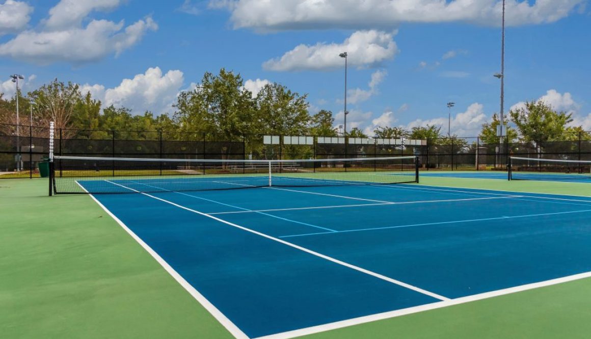 Outdoor tennis court in the sun, ideal example for facilities using tennis court booking software to manage reservations and access.