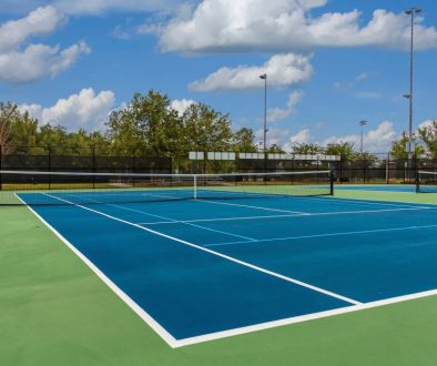 Tennis Court from Corner Outdoor tennis court in the sun, ideal example for facilities using tennis court booking software to manage reservations and access.
