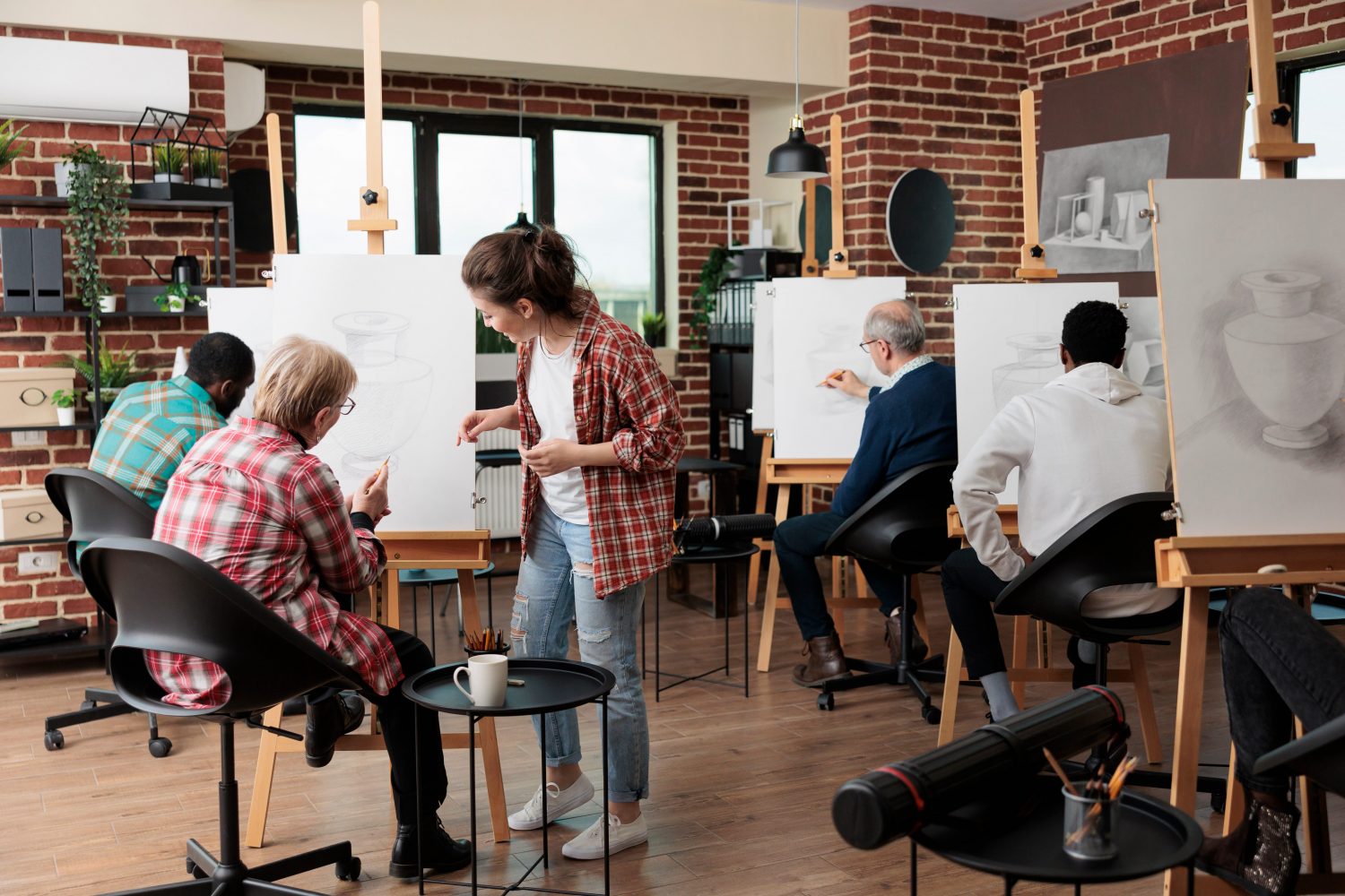 Senior woman attending an art class at a local community center - an example of programming managed through community center management systems.