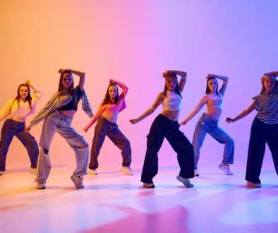 Group of active people, talented dancing hip hop against gradient studio background in neon light. Contemp Group of active people, talented dancing hip hop against gradient studio background in neon light. Contemp