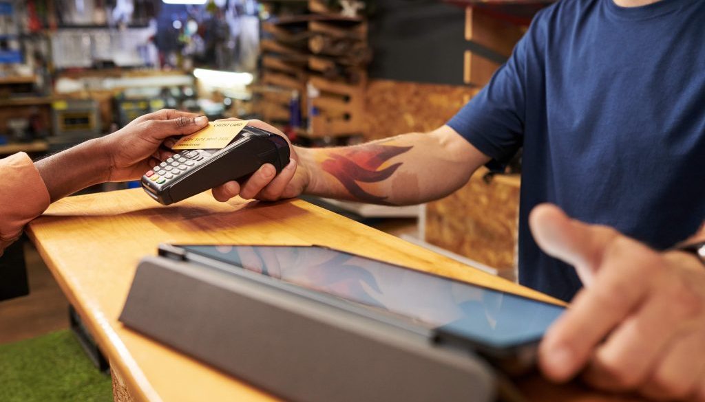 Young Man Assisting Black Man Making Contactless Payment