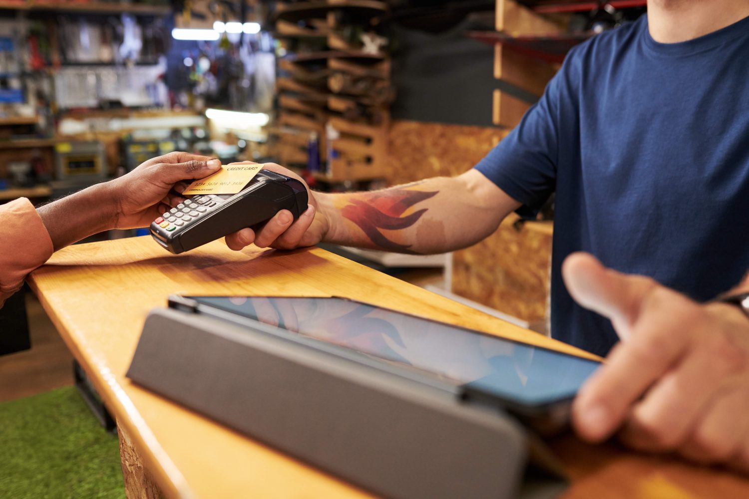 Young Man Assisting Black Man Making Contactless Payment