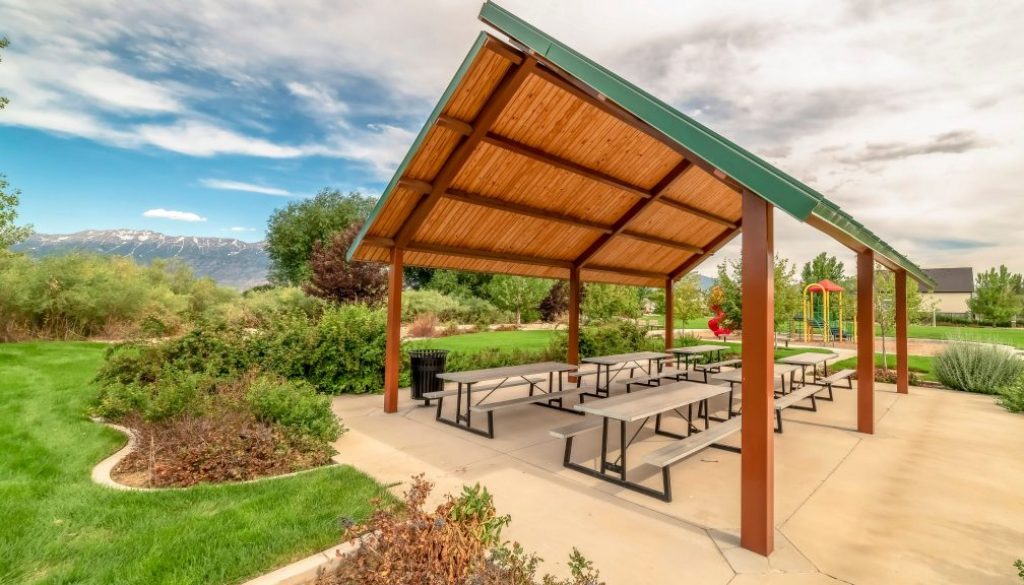Pavilion and playground managed with parks and recreation management software at a community park with mountains in the background