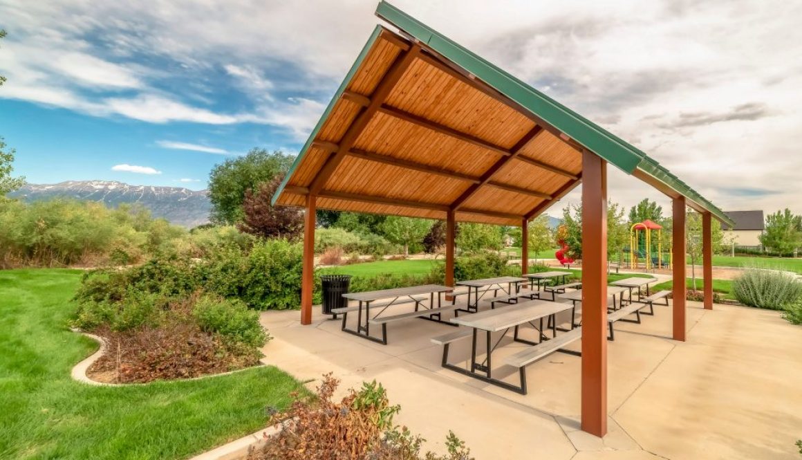 Pavilion and playground managed with parks and recreation management software at a community park with mountains in the background