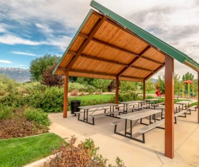 Pavilion and playground managed with parks and recreation management software at a community park with mountains in the background