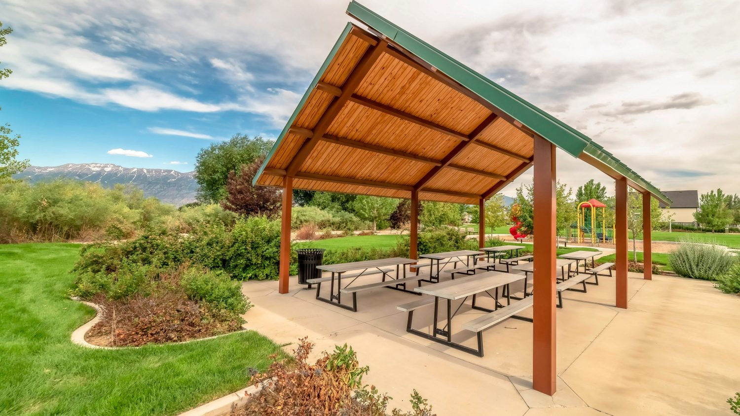 Pavilion and playground managed with parks and recreation management software at a community park with mountains in the background